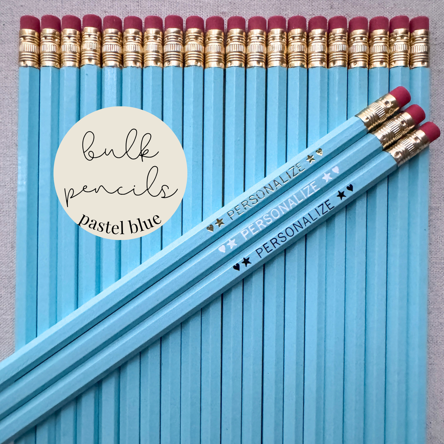 Pastel blue bulk personalized pencils flat lay in a box with custom text hand-pressed made in the USA for schools events and corporate orders
