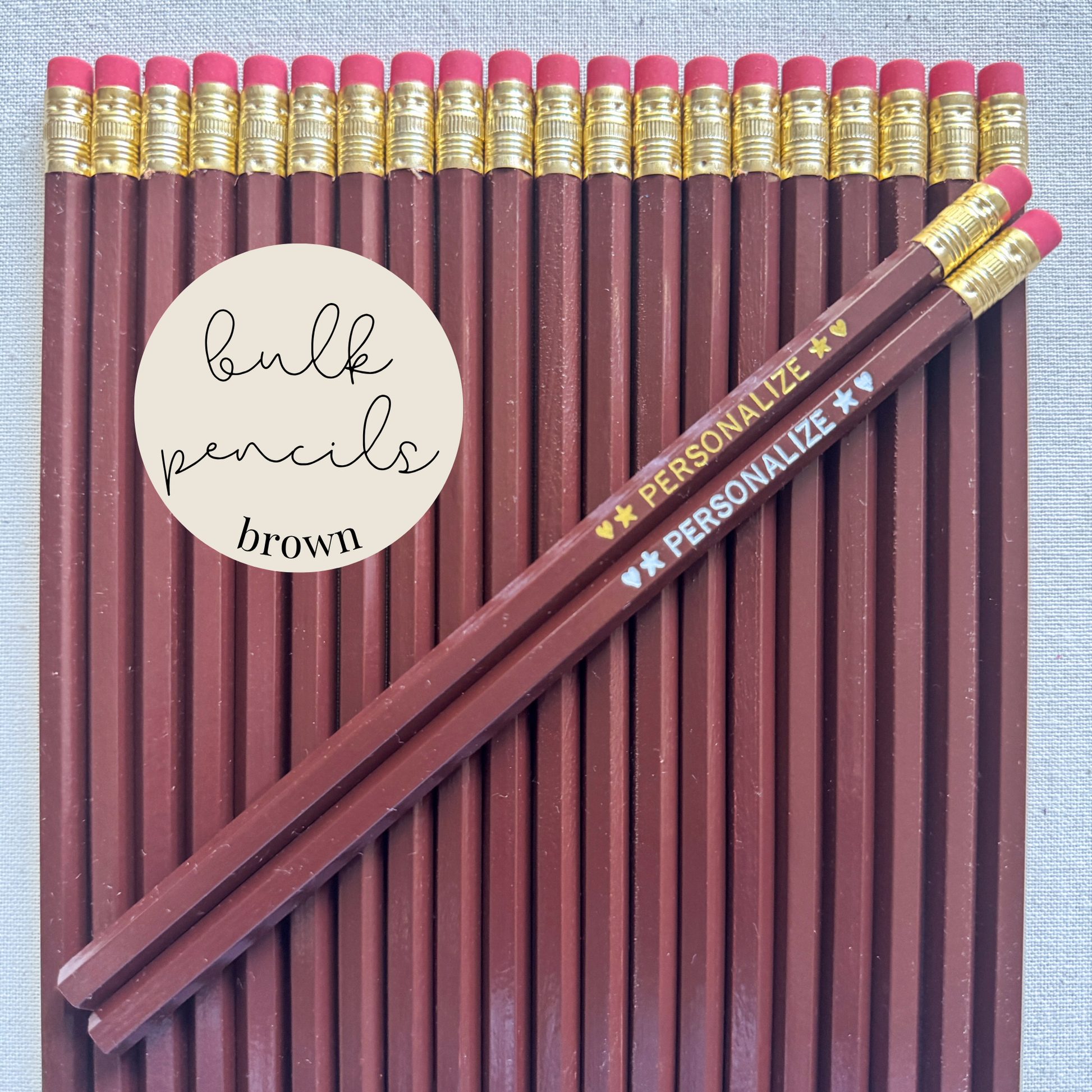 Brown bulk personalized pencils flat lay in a box with custom text hand-pressed made in the USA for schools events and corporate orders