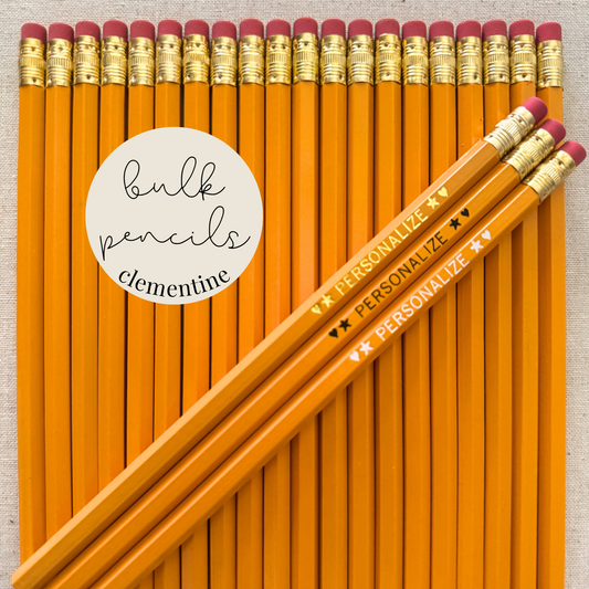 Clementine orange bulk personalized pencils flat lay in a box with custom text hand-pressed made in the USA for schools events and corporate orders
