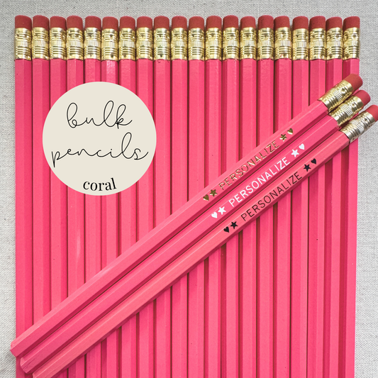 Coral pink bulk personalized pencils flat lay in a box with custom text hand-pressed made in the USA for schools events and corporate orders