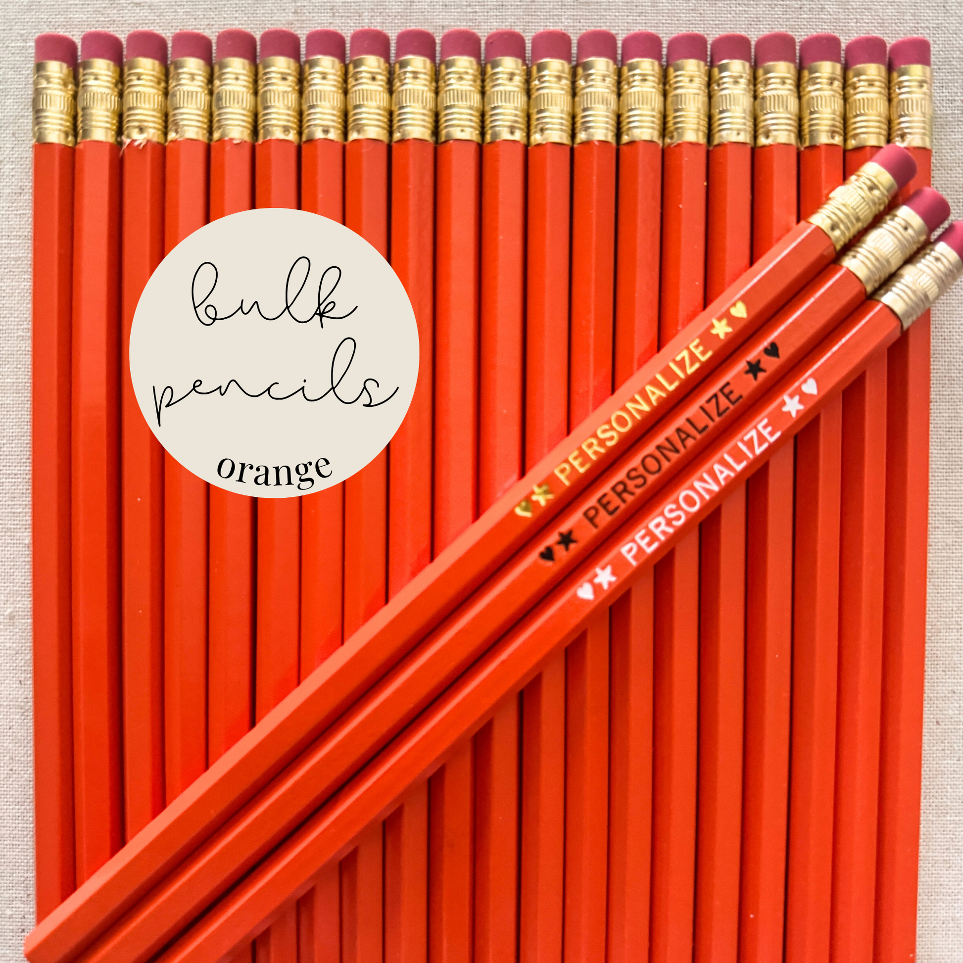 Orange bulk personalized pencils flat lay in a box with custom text hand-pressed made in the USA for schools events and corporate orders