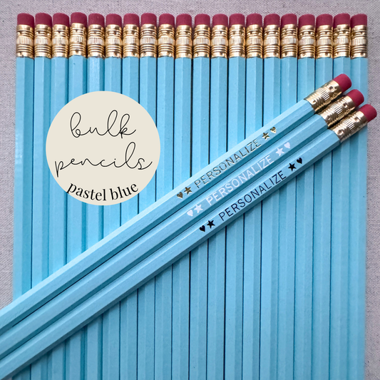 Pastel blue bulk personalized pencils flat lay in a box with custom text hand-pressed made in the USA for schools events and corporate orders