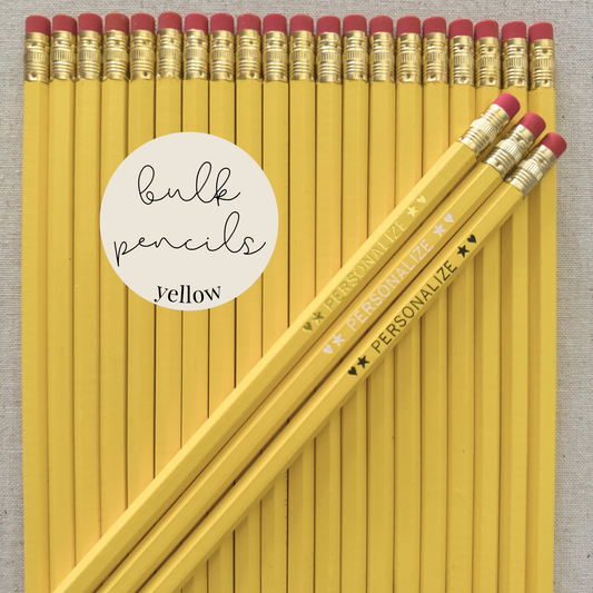 Yellow bulk personalized pencils flat lay in a box with custom text hand-pressed made in the USA for schools events and corporate orders